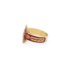 The Story A vintage cigar band ring from the late 20th century. Made in 10 karat yellow gold, the classic design is done with inlayed red enamel. "LA CORONA TABACO" is seen at its center within its tall oval shape. The combination of the warm yellow gold with the deep red enamel gives the ring a striking look. Flat in construction, it measures 0.59" tall. A beautiful ring with its color, design, and flat construction, we love it worn on its own or paired with your favorite pieces. The Specs Styl Vintage Gold Enamel Ring Stamped 14k, Vintage Red Signet Ring Stamped 14k, Classic Gold Enamel Ring, Vintage Yellow Gold Enamel Rings, Classic Gold Enamel Signet Ring, Vintage Enamel Anniversary Ring, Classic Yellow Gold Enamel Ring Collectible, Vintage Red Engraved Signet Ring, Red Engraved Vintage Signet Ring