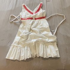 Nwot Excellent Condition. White Sundress With Buttons Down Front And Red Embroidery Around Collar And Waist. Ties In Back. From Smoke Free Home. No Flaws For Pilling. White Sleeveless Ruffled Sundress, Red Sleeveless Beach Dress With Ruffles, Red Ruffled Sleeveless Beach Dress, White V-neck Sleeveless Dress With Ruffles, Red Cotton Sleeveless Vacation Dress, Red Sleeveless Cotton Sundress, White Cotton Sleeveless Beach Dress, Red Cotton Sleeveless Sundress, Casual Sleeveless Dress For Holidays