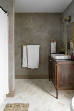 a bathroom with two towels hanging on the wall