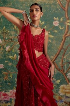 Red net lehenga with an attached cancan and floral, thread, beads and sequins emboidery. Comes with a padded blouse and a chiffon and organza ruffled drape. - Aza Fashions