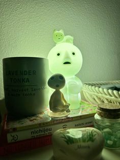 a lamp that is on top of a table next to some books and other items