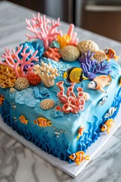 there is a blue cake decorated with corals and sea animals on it's side