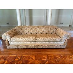 a couch sitting on top of a hard wood floor