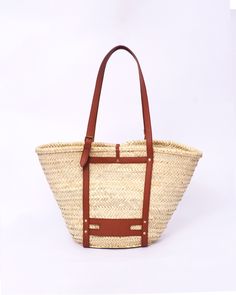 Do you want to look stylish and hippy? Get your hands on this handmade straw bag. It's high quality, eco-friendly, and handcrafted by women in Morocco. Its design is unique and timeless. Get yours now! we are proud to introduce our signature straw french bag to you. it is handmade by our talented artisan who has been working with us for years. this beautiful bag has a unique design that you would find nowhere else. the light and durable material are ideal for taking the bag on your adventures. S Bohemian Woven Bags For Vacation, Bohemian Handwoven Bags For Vacation, Bohemian Handwoven Shoulder Bag For Vacation, Bohemian Beige Bags For Vacation, Beige Bohemian Bags For Vacation, Bohemian Brown Shoulder Bag For Summer, Bohemian Straw Bag With Adjustable Strap For Everyday Use, Bohemian Summer Bucket Bag For Vacation, Bohemian Brown Straw Bag For Vacation