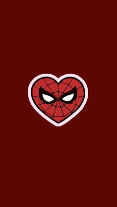 the face of spider - man in a heart shaped sticker on a red background