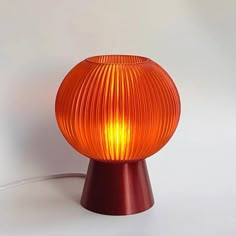 Bring a touch of warmth and elegance to your space with this Amber Table Lamp, inspired by the soothing hues of a sunset. The amber-colored lampshade casts a calming, ambient glow that creates a cozy, inviting atmosphere in any room. Perfect for adding a decorative accent while providing practical lighting, this lamp enhances any desk, bedside table, or shelf with a modern, minimalist look. Standing at 21 cm (8.3 inches) in height and 16.5 cm (6.5 inches) in width, this lamp offers a compact design that fits seamlessly into any space without overwhelming it. The rounded, mushroom-like shape adds a playful yet refined touch, making it suitable for various decor styles, from contemporary to vintage-inspired. This lamp is equipped with a 1.8-meter (5.9 feet) cord, featuring an easy-to-use swi Amber Table, Bnb Decor, Mcm Lamp, Orange Lamp, Lamp Mushroom, Lamps Unique, Orange Lamps, Red Table Lamp, Sunset Lamp