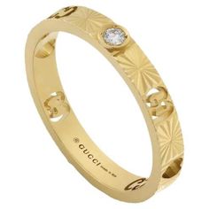 an 18k yellow gold ring with diamond set in the center and floral design on the outside