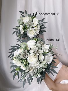 a bridal bouquet with white flowers and greenery