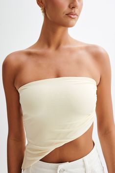 Exude elegance.The DONATA Slinky Strapless Top is a chic and stylish choice for those looking to add a dash of elegance to their wardrobe. This top features a strapless design that highlights the shoulders and collarbone, making it an excellent option for both casual and formal occasions. The asymmetrical hem adds a contemporary and artistic flair, offering a unique silhouette that sets it apart from traditional tops. Side gatherers provide a flattering ruched effect, enhancing the body's curves Chic Summer Tube Top With Built-in Bra, Stretch Tube Top With Built-in Bra For Evening, Elegant Summer Tube Top With Built-in Bra, Summer Fitted Off-shoulder Halter Top, Spring Off-shoulder Tube Top With Built-in Bra, One Shoulder Top With Built-in Bra And Stretch, Fitted Off-shoulder Halter Top For Summer, Elegant Stretch Bandeau Tube Top, One Shoulder Stretch Top With Built-in Bra