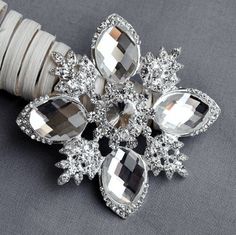 "This listing is for ONE piece of Sparkling rhinestone crystal brooch, which can be used on brooch bouquet, bomboniere boxes, ring pillows, invitations, place cards, wedding cake decoration etc. Measurements (approx): 2.5\" (63mm) in diameter Materials: silver metal A+ grade rhinestones Qty: 1 pc Back: pin back The product is for the above mentioned rhinestone component only, not including all other images/products/designs, which are used for decoration suggestions and ideas. Other shapes are av Bouquet Cake, Brooch Wedding, Bridal Brooch Bouquet, Wedding Brooch Bouquets, Ring Pillows, Headband Holder, Bling Wedding, Wedding Cake Decorations, Crystal Buttons