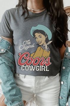 Show off your love for the Wild West with The Original Coors Cowgirl Graphic T Shirts. Made with soft and comfortable material, these shirts showcase a classic cowgirl riding a horse with the iconic Coors logo in the background. Perfect for any cowgirl or beer lover in your life! SPECIFICATIONS: Unisex Crew Neck Short Sleeve Tees. Crafted from premium materials, tailored to your lifestyle, ensuring a comfortable fit for any occasion. Family Group Uniforms Birthday Party Gift Concert Festival Events. High Quality Direct To Film Printed Graphic Design. 100%COTTON,HEATHER(52%COTTON,48%POLY),ATH.HEATHER,BLACK HEATHER(90%COTTON,10%POLY) Made In: Nicaragua Coors Logo, Classic Cowgirl, Cowgirl Graphic, Riding A Horse, Green Ash, Concert Festival, The Wild West, Film Prints, Birthday Party Gift