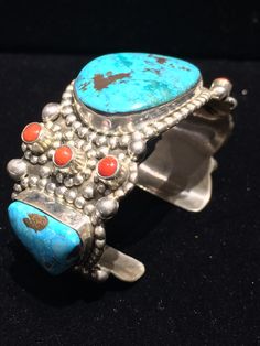 "- This listing is just for the one cuff that appears alone in the pictures... The others are also available in my shop in the section titled \"Fine Jewelry\". Please have a look... Highly regarded & collectible, Wayne Aguilar of Santo Domingo Pueblo, Native American Indian made multi-stone highly decorated sterling silver cuff... Stones include Turquoise (2, one with pyrite), coral (6) & chrysocolla (1, with malachite & cuprite). Silver studs form surrounding patterns around stones. Traditional Multi-stone Collectible Jewelry, Unique Multi-stone Cuff Bracelet Gift, Unique Multi-stone Cuff Bracelet As A Gift, Silver Artisan Multi-stone Cuff Bracelet, Artisan Silver Multi-stone Cuff Bracelet, Unique Adjustable Multi-stone Cuff Bracelet, Artisan Sterling Silver Cuff Bracelet For Collectors, Unique Ceremonial Jewelry With Natural Stones, Traditional Turquoise Sterling Silver Cuff Bracelet