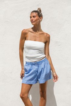 Expertly crafted with a ribbed knit, our High Noon Tube Top offers both comfort and versatility. Its long length provides ample coverage and pairs well with high-waisted bottoms. Perfect by itself or to layer under a breezy button up, this white sweater tube top is a must-have for any wardrobe. Versatile Fitted Ribbed Bottoms, Stretch Ribbed Bottoms, Spring Ribbed Bottoms Short Length, Solid Ribbed Bottoms For Summer, Ribbed Short Length Tops For Spring, Spring Cotton Ribbed Bottoms, Spring Ribbed Cotton Bottoms, Chic Seamless Spring Bottoms, Seamless Bottoms For Spring