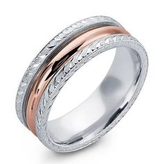 a wedding ring with intricate engraving on the sides and an engraved pattern in the middle