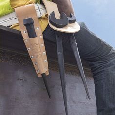 a man sitting on top of a bench with tools