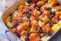 a casserole dish filled with blueberries and potatoes