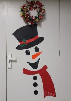 a door decorated with a snowman and wreath