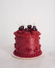 a red cake sitting on top of a white table