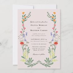 a wedding card with flowers and leaves on the front, in pastel pink background