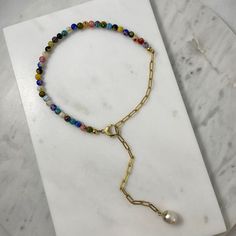 "Half murano millefiori beads half gold paperclip chain necklace connected by a beautiful clasp closure, adorned with a pearl pendant charm. It's your new favorite necklace perfect for wearing it solo or layer it with other chains. ★ Complete the look ★ https://www.etsy.com/listing/1292779124/18k-gold-paperclip-necklace-murano Details * Material: 18K Gold plated stainless steel chain * Chain Style: Paperclip * Chain Length: 45cm - 18\" inches long including the clasp. * Multicolor murano millefi Multicolor Paperclip Chain Necklace As Gift, Multicolor Paperclip Chain Jewelry For Gifts, Multicolor Paperclip Chain Necklace For Gift, Multicolor Paperclip Chain Necklace Gift, Half Chain Necklace, Gold Link Chain Necklace, Millefiori Beads, Pearl Charm Necklace, Paperclip Necklace