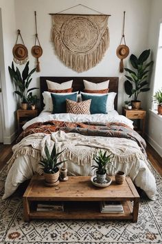 a bed with pillows, blankets and plants on it