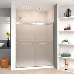 a bathroom with a walk in shower next to a white shelf filled with towels and other items