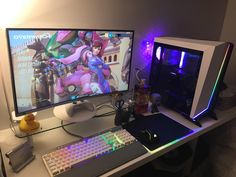 two computer monitors sitting next to each other on top of a white desk with a keyboard and mouse