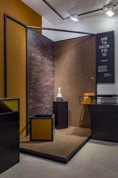 a room with some black and yellow furniture in it's display area, as well as an advertisement on the wall that says mementoe mork 51