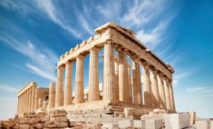 the ruins of an ancient greek temple under a blue sky