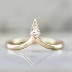 a yellow gold ring with a single diamond