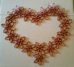 a heart made out of paper with red flowers