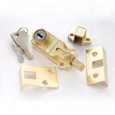 several different types of locks and keys on a white surface with one open lock, the other closed