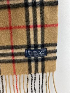 Description : Vintage Burberry scarf. 100% cashmere. Traditional Burberry nova check plaid in tan/red/black/white. Small moth hole - price reflects Item Number : P28 Category : Scarf Brand : Burberry Burberry Inspired Scarf, Burberry Scarves & Shawls, Burnerry Cotton Scarf, Burberry Vintage Scarf, Disneyland Sweatshirt, Burberry Plaid, Burberry Classic, Burberry Scarf, Burberry Vintage