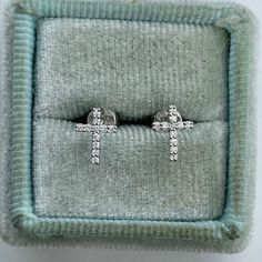 Dainty Diamond Cross Earring Studs.  Simple and pretty diamond cross studs for everyday wear.  The diamonds are nice and sparkling.  Cross measures about 8 x 5.8mm.  Strong and secure push backs.   Genuine Round Brilliant Cut Diamonds  Total weight: 0.10 carat Clarity: SI Color: G Solid 14K White Gold Comes with gift box * We have been in the wholesale Jewelry business for over 30 years serving the community at the same location.  All diamonds we use are natural stones and fine quality gold.  Absolutely NO clarity enhanced or treated diamonds. Our jewelry pieces are handcrafted with fine craftsmanship and good quality stones. Our prices are wholesale prices.  We strive to bring you the best value for your money and have you as a repeat customer. If for one reason or another your order did Diamond Cross Earrings, Gold Cross Earrings, Cross Earring, Earrings Cross, Cross Earrings Studs, Tiny Cross, Earring Studs, Diamond Cross, Sell Gold