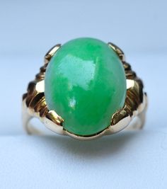 "Category Type: Rare Fine Jewelry Metal Purity:14K Yellow Gold Ring Size US: 4 3/4 Center Stone: Highest Quality Grade \"AAA\" Untreated Jadeite Jade Stone Creation: Grade \"A\" Finest Untreated Imperial Quality Jadeite Jade Additional Stones: Natural Diamond Accent Jadeite Stone Size: 6 Carat - 15mm x 12mm Ring Total Weight: 4.7 grams Condition: Preowned / Like New" Heirloom Green Emerald Oval Cabochon Ring, Heirloom Green Oval Cabochon Emerald Ring, Heirloom Green Opal Round Ring, Heirloom Green Opal Ring, Green Opal Oval Ring In 14k Gold, Classic Green Cabochon Emerald Ring, Classic Green Opal Ring In 14k Gold, Green 14k Gold Emerald Ring Collectible, Collectible Green Emerald Ring In 14k Gold