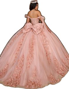 a woman in a pink ball gown with a tiara