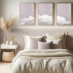 a bedroom with three pictures on the wall above the bed