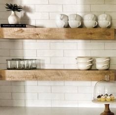 the shelves in the kitchen are filled with dishes