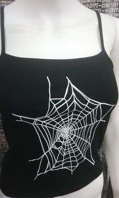 This is a black sleeveless Spiderwebs cropped tank top. This has a Spiderweb image screen printed on the front. 57% cotton/ 38% polyester/ 5% Spandex These are handmade screenprinted and slightly vary from the photo. Please feel free to email me any questions. Thanks for looking. Due to an influx of incorrect addresses if a package is returned, you must pay the shipping cost to resend the item to you. I do not do exchanges and I do not take returns unless the item is damaged. I thoroughly check Edgy Black Tank Top For Halloween, Punk Black Tank Top For Halloween, Punk Style Black Tank Top For Halloween, Black Tank Top For Halloween Festival, Punk Stretch Tank Top For Halloween, Black Stretch Tank Top For Halloween, Edgy Stretch Tank Top For Halloween, Fitted Black Emo Tank Top, Black Fitted Grunge Tank Top