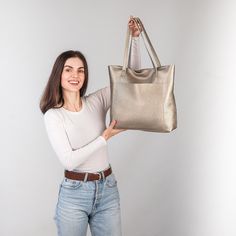 This handmade women tote bag is produced by Italian soft pebbled leather. It has one pocket inside. The bag has a high-quality zipper that secures your belongings. It holds the shape perfectly and you may be confident that your things like cell phone, tablet, lap-top are safe. This bag is simple, reliable, and durable. Its universal look allows using the tote bag for various purposes. One may take the bag to the work, shopping, meeting, or walk and feel comfortable with it in any condition. Size and Dimensions:       〰️ SMALL 〰️ Height: 12 inches (30 cm) Width (the top): 12.6 inches (32 cm) Width (the bottom): 9 inches (23 cm) Depth: 4.3 inches (11 cm)      〰️ MEDIUM 〰️ Height: 13.4 inches (34 cm) Width (the top): 14.6 inches (37 cm) Width (the bottom): 11 inches (28 cm) Depth: 4.3 inches Rectangular Pebbled Leather Shoulder Bag For Shopping, Gold Soft Leather Bag For On-the-go, Everyday Gold Bucket Bag, Rectangular Pebbled Leather Bucket Bag For Daily Use, Everyday Soft Leather Gold Bag, Pebbled Leather Tote Bucket Bag For Everyday Use, Leather Satchel Shoulder Bag With Pebbled Texture, Pebbled Leather Tote Shoulder Bag, Rectangular Shoulder Bag With Pebbled Texture