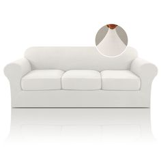 a white couch with an oval mirror on it's back end and the seat upholstered