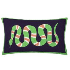 a green and orange snake pillow on a black background