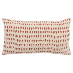 an orange and white pillow with red hearts on the front, sitting on a white background