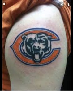 a chicago bears tattoo on the back of a woman's shoulder