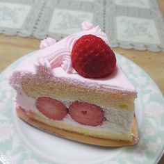 a piece of cake with strawberries on top