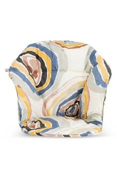 a colorful chair that is sitting on a white surface with an orange, yellow and blue pattern