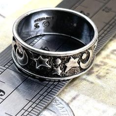 Vintage Wide Crescent Moon Stars Sterling Silver Band Ring Size 7.5 Celestial Symbols  Smoke free. Artist signed jewelry, solid sterling silver band ring, marked Sterling with dollar sign symbol mark. Has patina, darkening, age and wear. Has a weathered look.  See photos to confirm all marks. See photos for ring on sizer showing size 7.5. See ring near ruler to verify width of band. Shows wear and age. True vintage. Boho, stacking, wedding, ring, artist, designer, signed, rustic, worn, thick, band, ring, pinky ring, stacking, stackable, thumb, boho wedding band, wizard, magic theme, darkened with age, astrology, wicca, wiccan, nature, goth, jewelry. Comes in a box in secure packing with tracking. Promptly shipped. Reliable seller. Boho Wedding Band, Nature Goth, Boho Wedding Bands, Celestial Symbols, Thick Band Ring, Wizard Magic, Magic Theme, Dollar Sign, Goth Jewelry