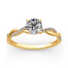 a yellow gold engagement ring with diamonds on the band and a round cut diamond in the center