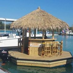 a boat dock with a tiki bar on it