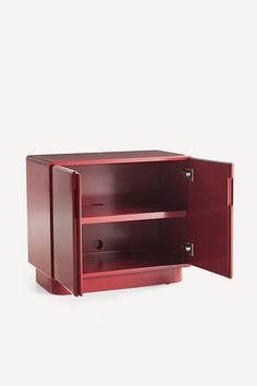 a red cabinet with two doors open on a white background and no one is in it